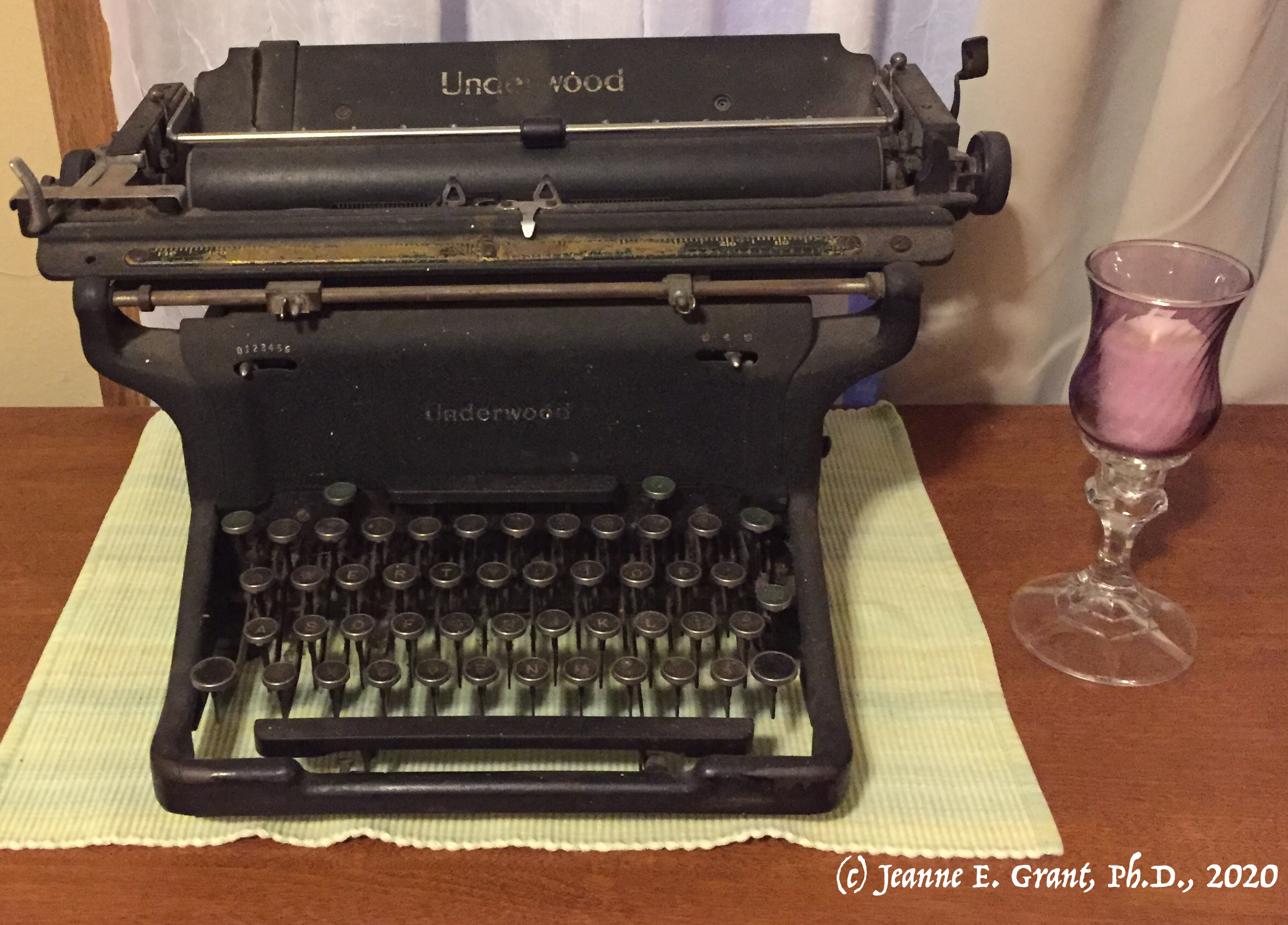 Photo of 1930s Underwood typewriter next to a candle